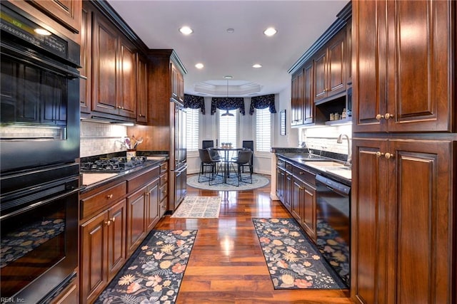 509 River Blfs, Williamsburg, VA 23185 - kitchen with black appliances, a sink, dark countertops, dark wood-style flooring, and tasteful backsplash