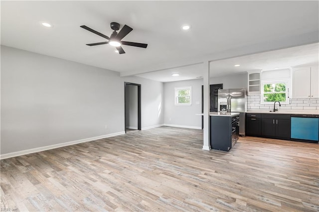 3004 Sunrise Ave, Chesapeake, VA 23324 - kitchen featuring dishwashing machine, open floor plan, backsplash, light wood finished floors, and ceiling fan