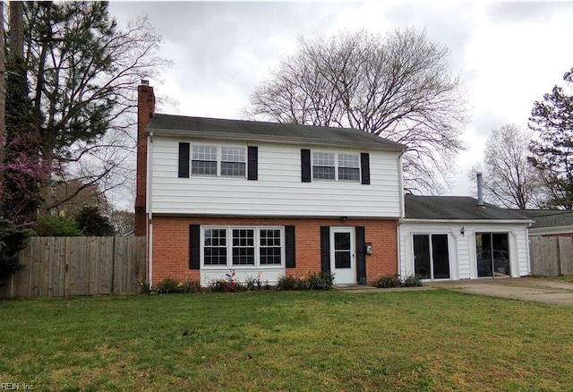 327 Nassau Pl, Hampton, VA 23666 - colonial home featuring a chimney, a garage, concrete driveway, and brick siding