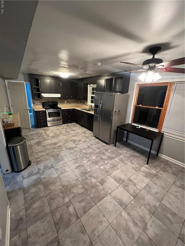 327 Nassau Pl, Hampton, VA 23666 - kitchen featuring stainless steel appliances, dark cabinetry, ceiling fan, under cabinet range hood, and tasteful backsplash