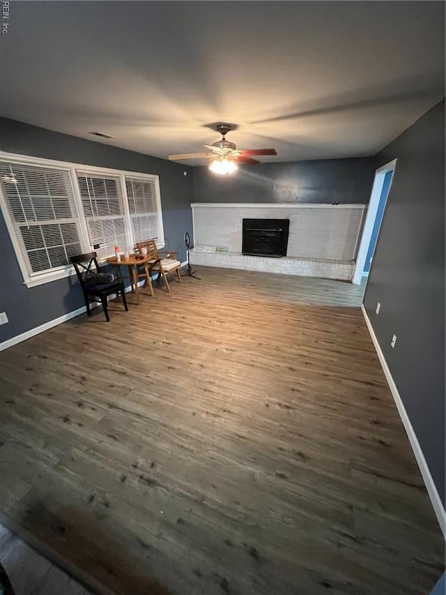 327 Nassau Pl, Hampton, VA 23666 - living room featuring wood finished floors, a ceiling fan, a brick fireplace, and baseboards