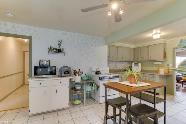 428 Macdonald Cres, Norfolk, VA 23505 - kitchen with white range with electric cooktop, light countertops, ceiling fan, light tile patterned flooring, and tasteful backsplash