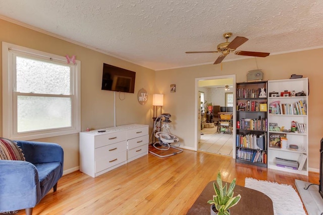 428 Macdonald Cres, Norfolk, VA 23505 - living area with a textured ceiling, ceiling fan, crown molding, light wood-type flooring, and baseboards