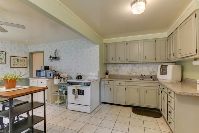 428 Macdonald Cres, Norfolk, VA 23505 - kitchen with white stove, light tile patterned flooring, light countertops, a sink, and wallpapered walls