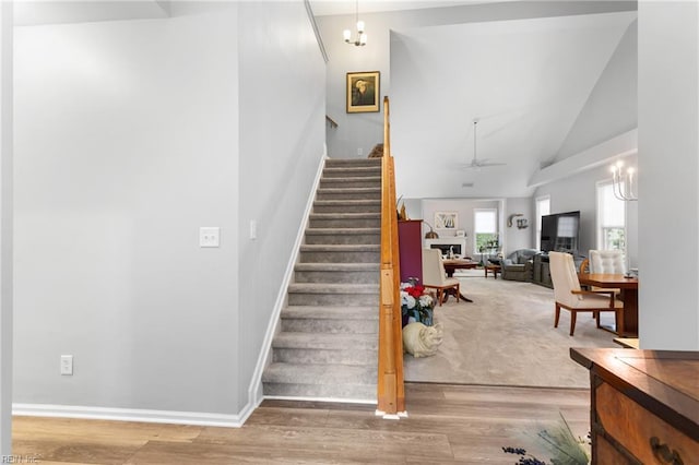 4731 Winterberry Ct, Williamsburg, VA 23188 - staircase featuring wood finished floors, high vaulted ceiling, a chandelier, baseboards, and ceiling fan
