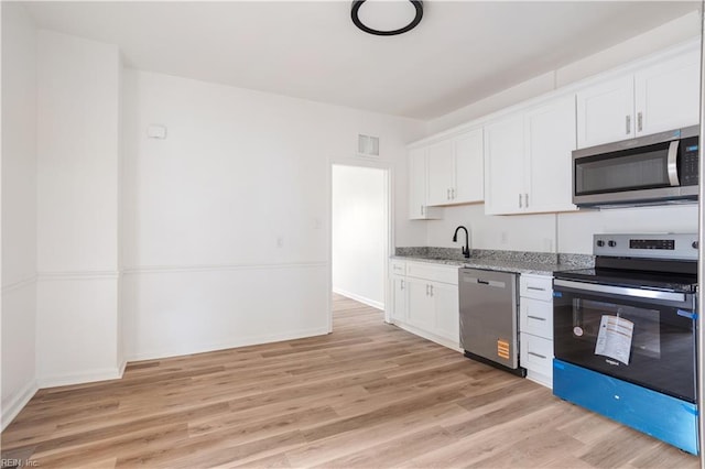 3711 Abingdon Cir, Norfolk, VA 23513 - kitchen featuring appliances with stainless steel finishes, light wood-style floors, a sink, light stone counters, and white cabinets