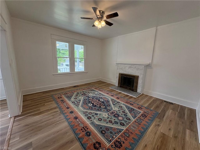 3711 Abingdon Cir, Norfolk, VA 23513 - unfurnished living room featuring ceiling fan, baseboards, wood finished floors, and a fireplace with raised hearth