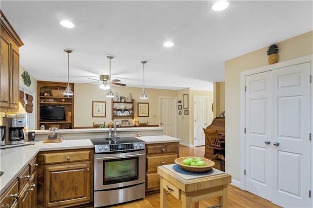 210 John Pott Dr, Williamsburg, VA 23188 - kitchen featuring stainless steel electric range oven, ceiling fan, a peninsula, light wood finished floors, and hanging light fixtures