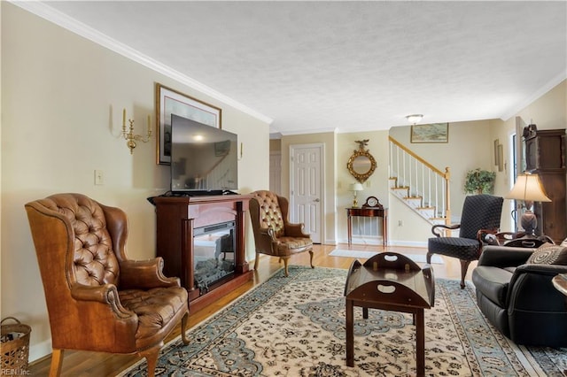 210 John Pott Dr, Williamsburg, VA 23188 - living room with stairway, a glass covered fireplace, wood finished floors, crown molding, and baseboards