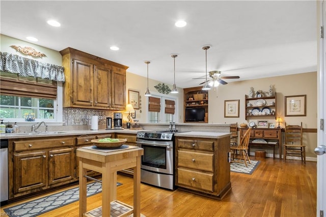 210 John Pott Dr, Williamsburg, VA 23188 - kitchen featuring stainless steel appliances, a peninsula, a sink, light countertops, and brown cabinets