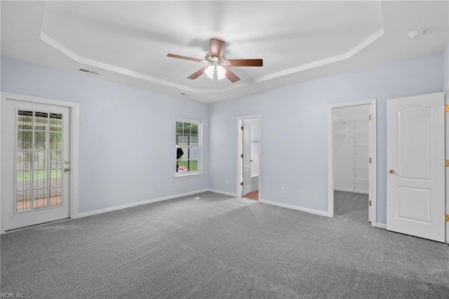 2110 King St, Suffolk, VA 23434 - unfurnished bedroom with a tray ceiling, multiple windows, and access to exterior