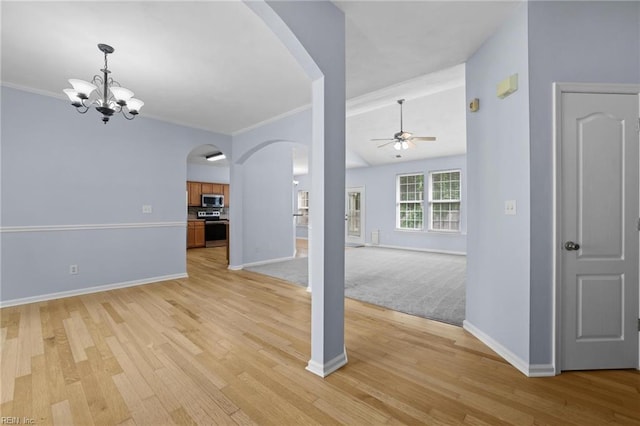 2110 King St, Suffolk, VA 23434 - unfurnished living room featuring arched walkways, a ceiling fan, baseboards, light wood-type flooring, and crown molding