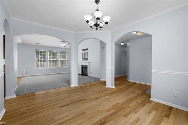 2110 King St, Suffolk, VA 23434 - unfurnished living room with ceiling fan, a glass covered fireplace, light wood finished floors, baseboards, and crown molding