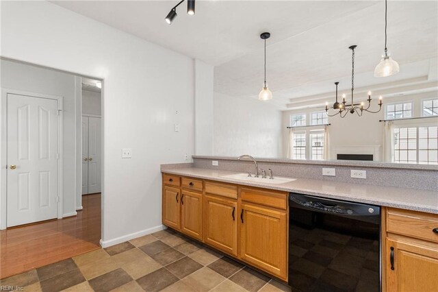 310 Lighthouse Way, Carrollton, VA 23314 - kitchen with black dishwasher, a chandelier, light countertops, a sink, and hanging light fixtures