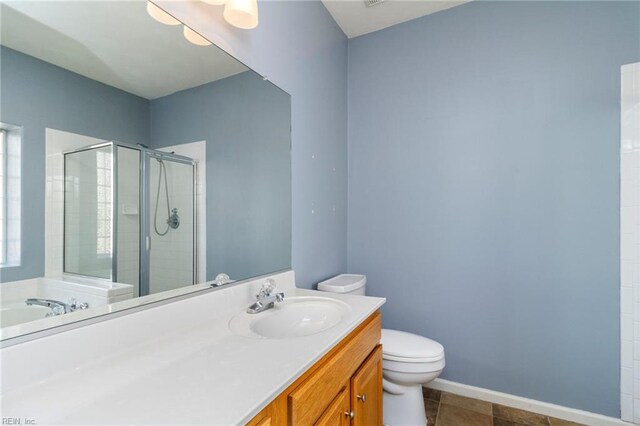 310 Lighthouse Way, Carrollton, VA 23314 - bathroom with toilet, a stall shower, vanity, and baseboards
