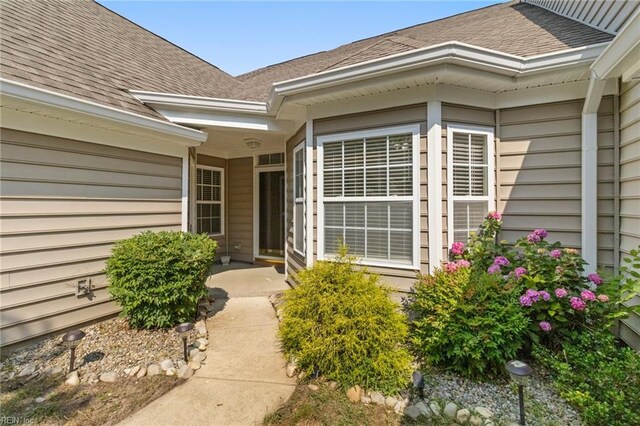 310 Lighthouse Way, Carrollton, VA 23314 - view of exterior entry featuring a shingled roof