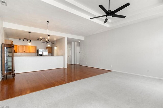 310 Lighthouse Way, Carrollton, VA 23314 - unfurnished living room with a chandelier, ceiling fan, dark wood-style floors, rail lighting, and baseboards
