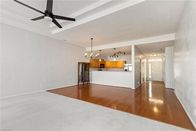 310 Lighthouse Way, Carrollton, VA 23314 - unfurnished living room featuring a chandelier, wood finished floors, and baseboards