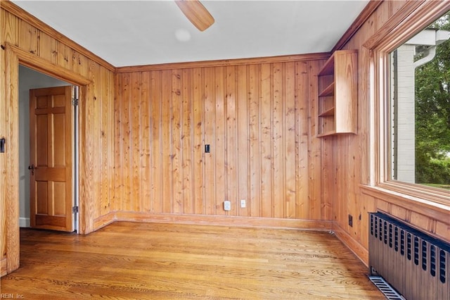 6414 Wythe Pl, Norfolk, VA 23508 - empty room featuring radiator, wood walls, light wood finished floors, and healthy amount of natural light
