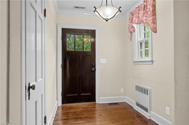 6414 Wythe Pl, Norfolk, VA 23508 - foyer entrance featuring radiator heating unit, baseboards, healthy amount of natural light, crown molding, and wood finished floors
