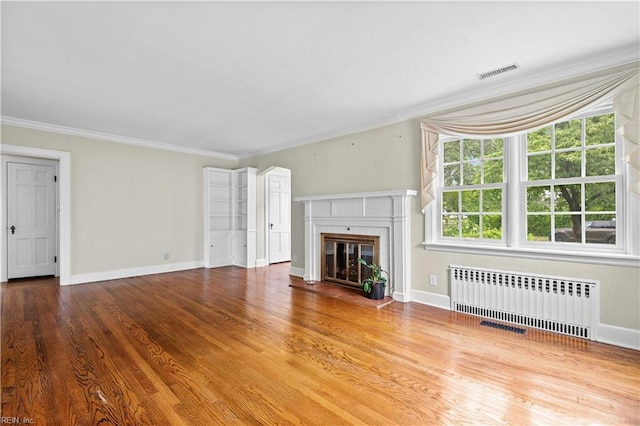 6414 Wythe Pl, Norfolk, VA 23508 - unfurnished living room featuring radiator heating unit, crown molding, a brick fireplace, baseboards, and wood finished floors
