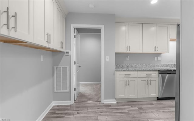 3506 Somme Ave, Norfolk, VA 23509 - kitchen with stainless steel dishwasher, light wood-style flooring, white cabinetry, light stone countertops, and baseboards