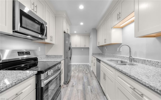 3506 Somme Ave, Norfolk, VA 23509 - kitchen with stainless steel appliances, a sink, recessed lighting, light wood-type flooring, and white cabinetry