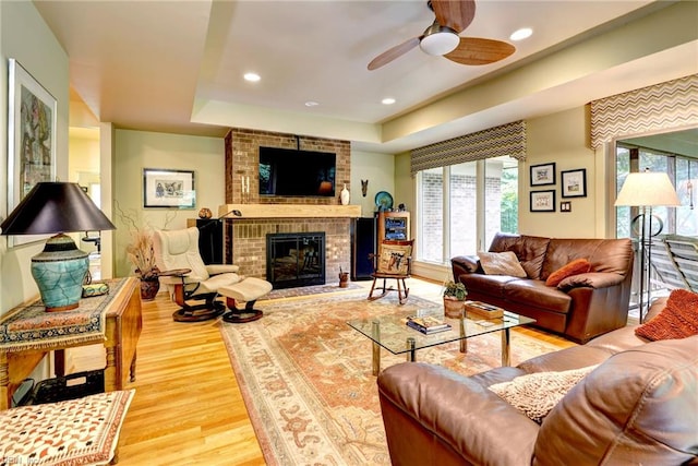 140 Hearthside Ln, Williamsburg, VA 23185 - living area with wood finished floors, ceiling fan, a tray ceiling, a fireplace, and recessed lighting