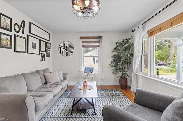 6615 Cabot Ave, Norfolk, VA 23502 - living room featuring a chandelier, wood finished floors, and baseboards