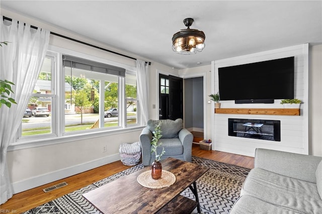 6615 Cabot Ave, Norfolk, VA 23502 - living area with baseboards, wood finished floors, and a glass covered fireplace