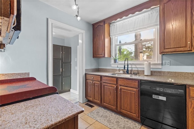 6615 Cabot Ave, Norfolk, VA 23502 - kitchen with black dishwasher, a sink, light tile patterned floors, brown cabinets, and rail lighting