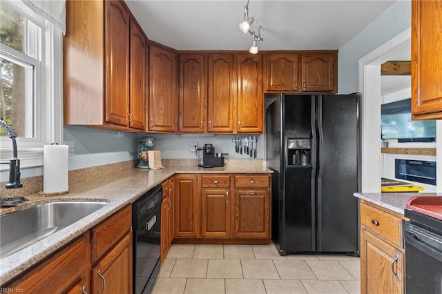 6615 Cabot Ave, Norfolk, VA 23502 - kitchen with black appliances, a sink, light tile patterned floors, and brown cabinets