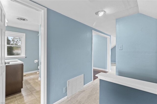 6615 Cabot Ave, Norfolk, VA 23502 - corridor featuring baseboards, lofted ceiling, and light tile patterned floors