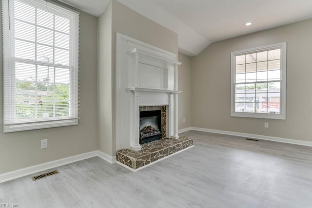 814 E 26th St, Norfolk, VA 23504 - unfurnished living room with wood finished floors, a fireplace with raised hearth, healthy amount of natural light, vaulted ceiling, and recessed lighting