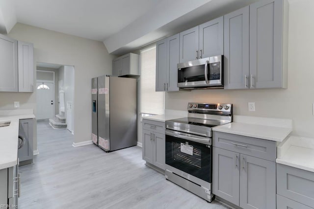 814 E 26th St, Norfolk, VA 23504 - kitchen featuring stainless steel appliances, gray cabinets, light countertops, and light wood-type flooring