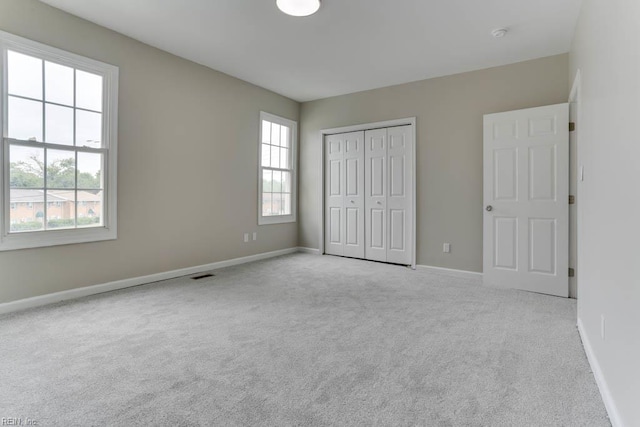 814 E 26th St, Norfolk, VA 23504 - unfurnished bedroom featuring carpet floors, multiple windows, and baseboards
