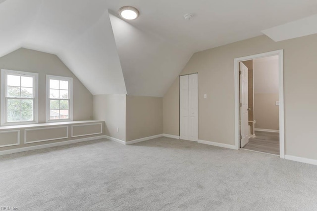 814 E 26th St, Norfolk, VA 23504 - bonus room with light carpet, vaulted ceiling, and baseboards