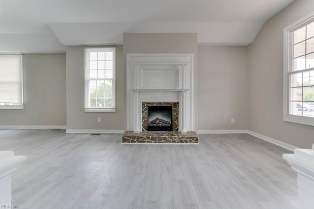 814 E 26th St, Norfolk, VA 23504 - unfurnished living room featuring wood finished floors, baseboards, a fireplace with raised hearth, and plenty of natural light