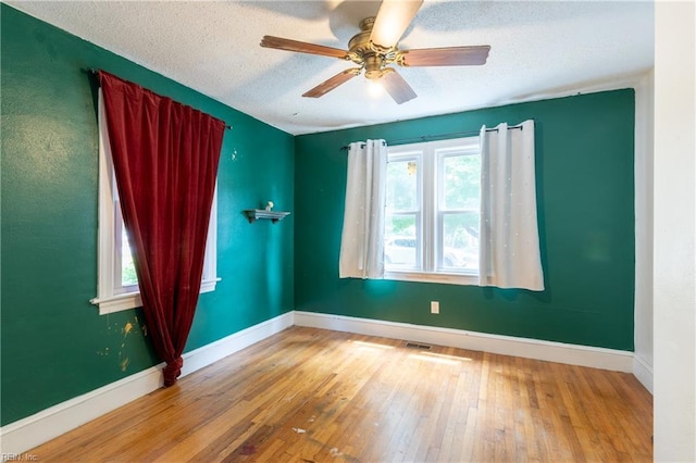 409 Wingfield Ave, Chesapeake, VA 23325 - empty room with hardwood / wood-style floors, baseboards, ceiling fan, and a textured ceiling