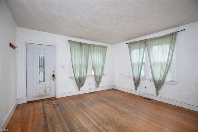 409 Wingfield Ave, Chesapeake, VA 23325 - entrance foyer with wood finished floors, a textured ceiling, and baseboards