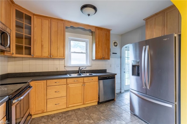409 Wingfield Ave, Chesapeake, VA 23325 - kitchen featuring appliances with stainless steel finishes, a sink, dark countertops, glass insert cabinets, and tasteful backsplash
