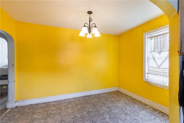 409 Wingfield Ave, Chesapeake, VA 23325 - empty room with arched walkways, a chandelier, and baseboards
