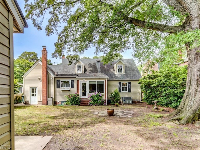 203 Sinclair St, Norfolk, VA 23505 - view of front facade with cooling unit, a shingled roof, and a chimney