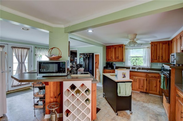 9206 Dixon Rd, Suffolk, VA 23433 - kitchen featuring black appliances, ornamental molding, a sink, brown cabinetry, and ceiling fan