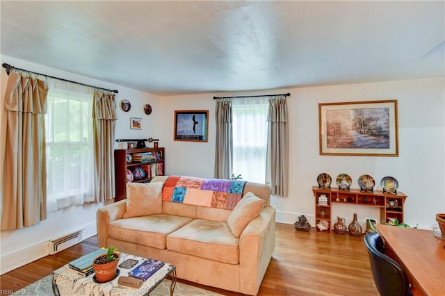 9206 Dixon Rd, Suffolk, VA 23433 - living room featuring wood finished floors, baseboard heating, and baseboards