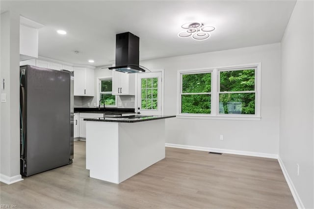 428 Maryle Ct, Newport News, VA 23602 - kitchen featuring freestanding refrigerator, island exhaust hood, white cabinets, dark countertops, and baseboards