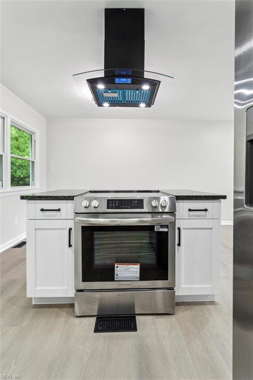 428 Maryle Ct, Newport News, VA 23602 - kitchen featuring stainless steel electric stove, range hood, dark countertops, white cabinetry, and light wood-type flooring