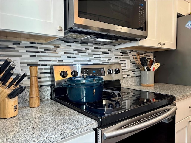 232 Mill Point Dr, Hampton, VA 23669 - kitchen featuring stainless steel appliances, backsplash, and white cabinetry