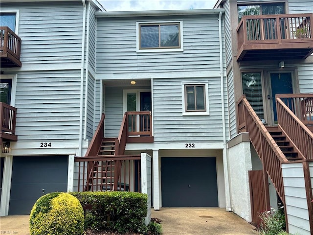 232 Mill Point Dr, Hampton, VA 23669 - view of front facade featuring stairs, an attached garage, and driveway
