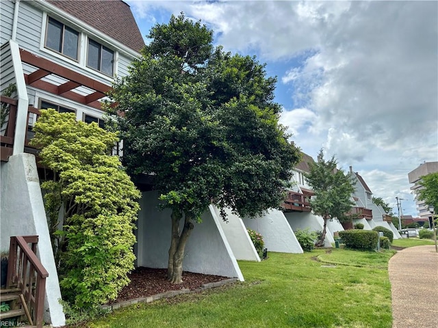 232 Mill Point Dr, Hampton, VA 23669 - view of side of property featuring a lawn and roof with shingles
